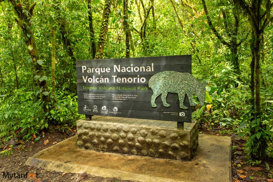 Tenorio Volcano National Park sign. Photo of a wooden sign that says "Parque Nacional Volcan Tenorio" and has a symbol of a tapir 