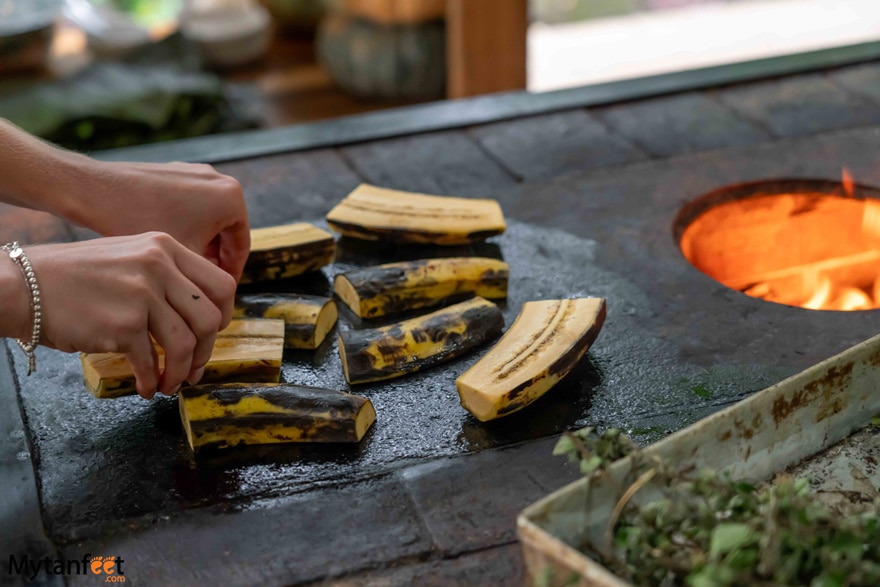 La Fortuna cooking class - putting plantains on the stove 