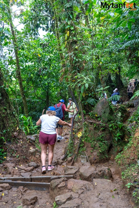 Tenorio volcano national park - photo of a group of adults walking on a trail with rocks and mud in a national park in Costa Rica 