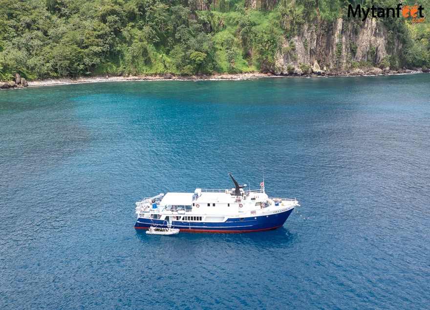 A yacht floating and docked at an island - the Okeanos Aggressor II at Cocos Island, Costa Rica 