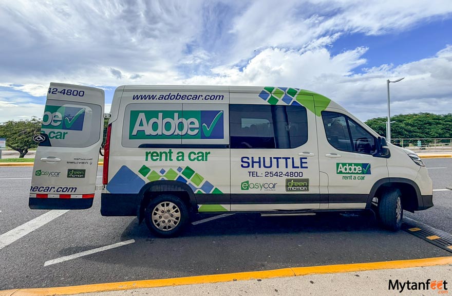 Car rentals from Liberia Airport - the Adobe Rent a Car shuttle parked on the curb of Liberia Airport