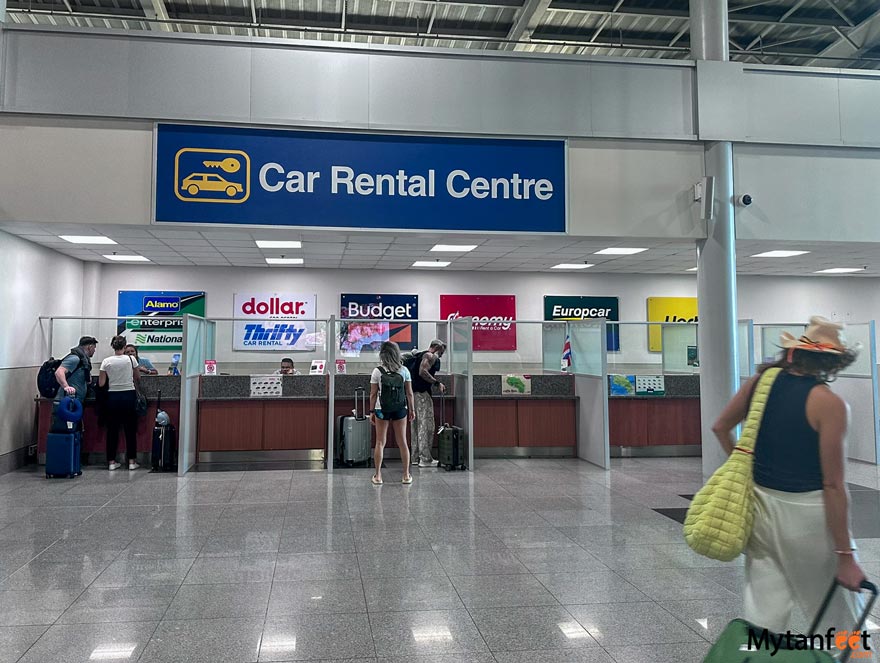 inside the baggage claim of Liberia Airport where the car rental centre counters are